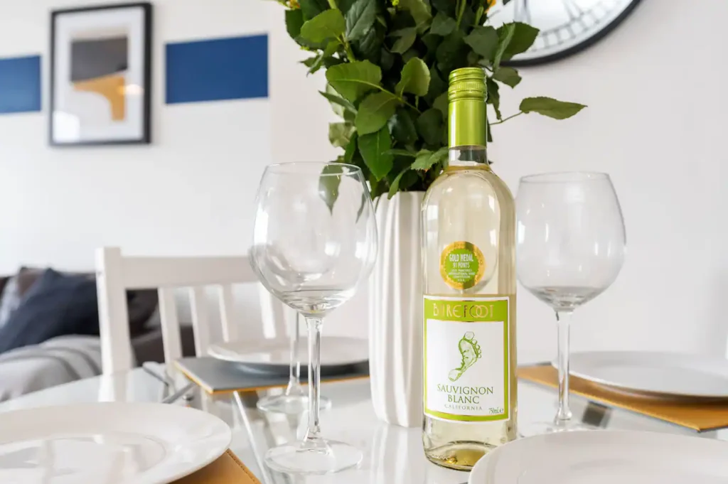 a wine bottle and wine glasses on a table