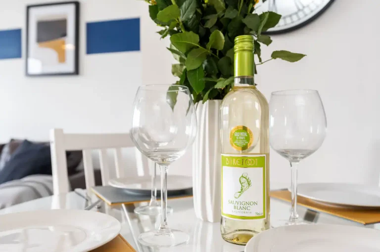 a wine bottle and wine glasses on a table