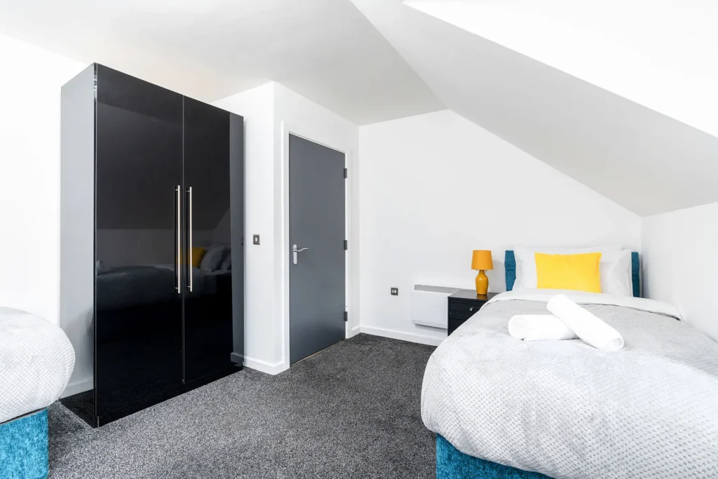 a bedroom with a black closet and a bed